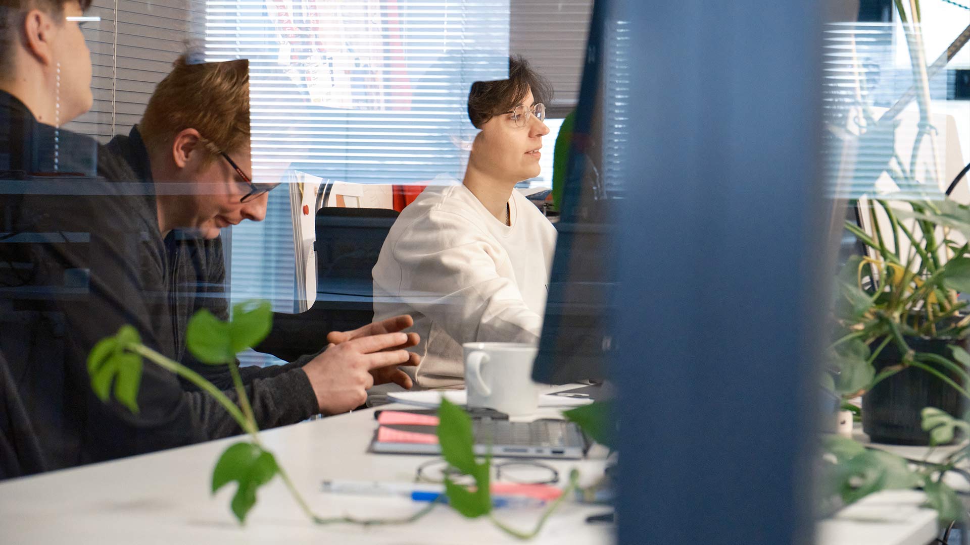 Tuxera employees working together at a computer